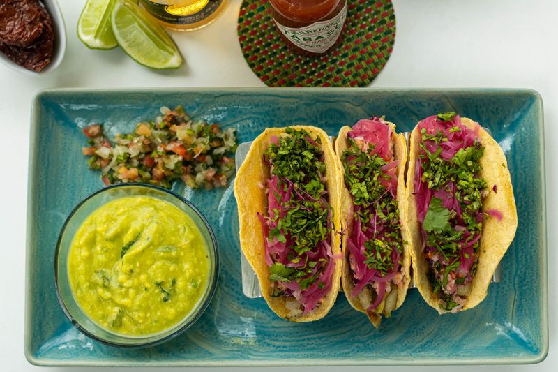 Slow-roasted pork carnitas burrito with fresh toppings